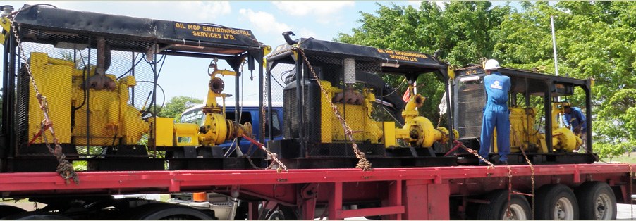Oil Mop Environmental Services pump skids loaded on a flatbed trailer