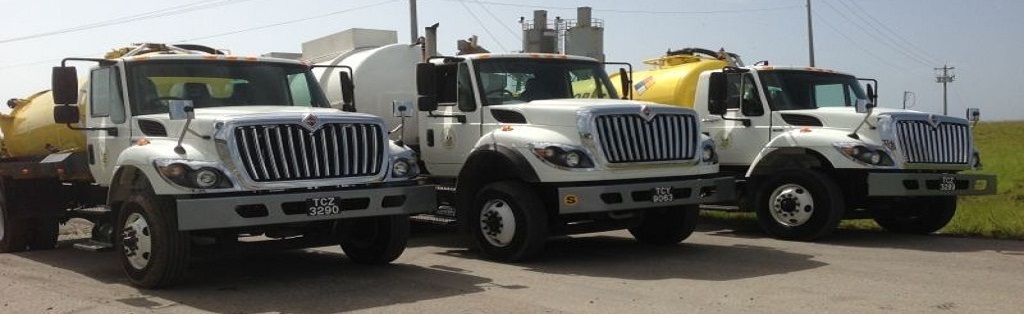 Three Oil Mop vacuum trucks lined up at the depot