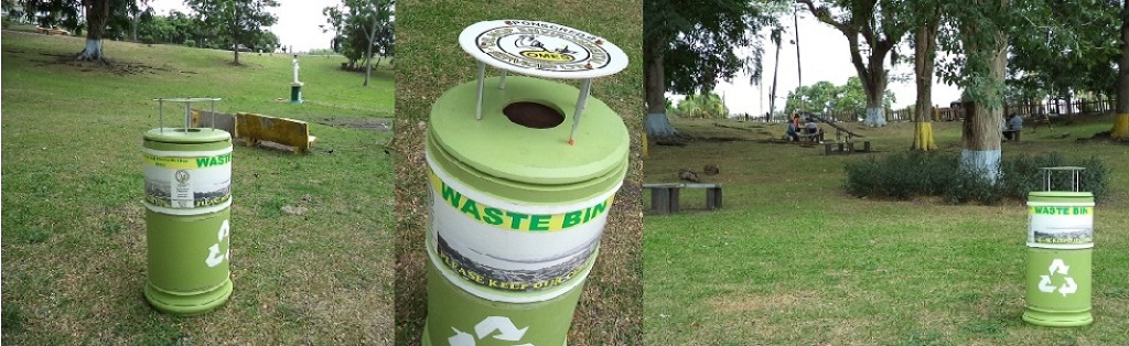Recycling waste bins sponsored by OMES in a public park as part of the company's green initiatives